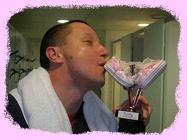 Cow Pat kissing his 70.3 trophy
